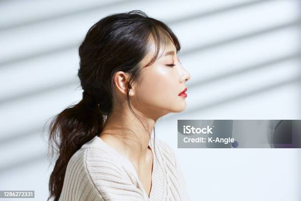 Beauty Portrait Of Young Asian Woman On The Light And Shadow Background Stock Photo - Download Image Now