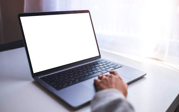 istock a businesswoman using and touching on laptop computer touchpad with blank white desktop screen on the table 1286276389