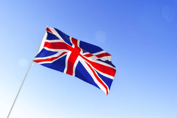 istock Flag of Great Britain waving against blue sky 1286276534