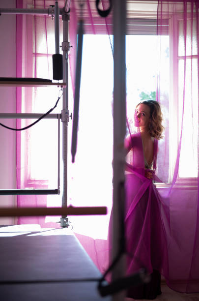 istock Woman Playing with the Curtain 1286277749