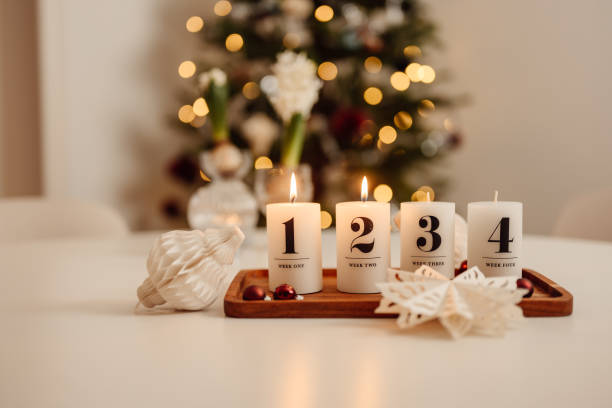 istock Christmas candle lights second advent on table indoors infront of christmas tree andra advent 1286280916