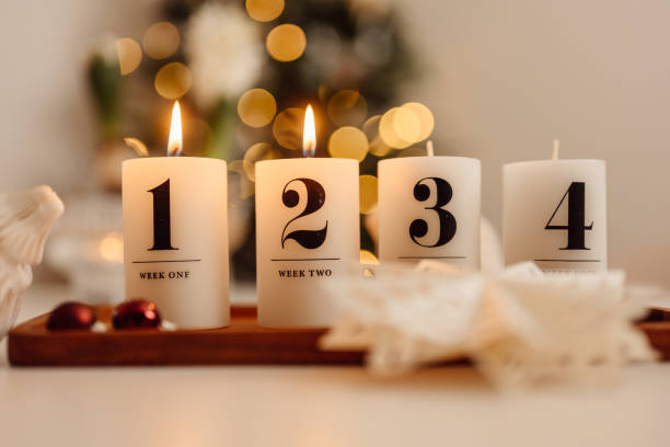istock Christmas candle lights second advent on table indoors infront of christmas tree andra advent 1286281901