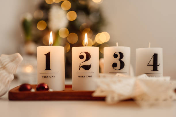 istock Christmas candle lights second advent on table indoors infront of christmas tree andra advent 1286283250