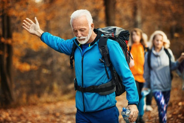 istock Senior folks hiking through a forest. 1286283653
