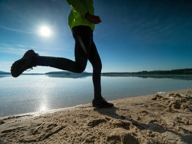 istock Dynamic Silhouette Of Athlete In Compression Running Tights Jogging. Man Doing Intervals Workout 1286284966