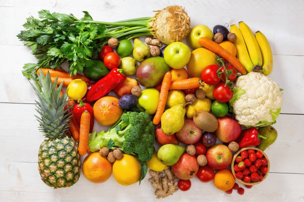 istock White wooden table full of fresh assorted fruit and vegetable 1286285096