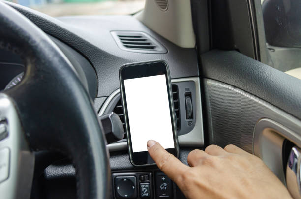 istock Man hand touch screen telephone in the car. 1286286509