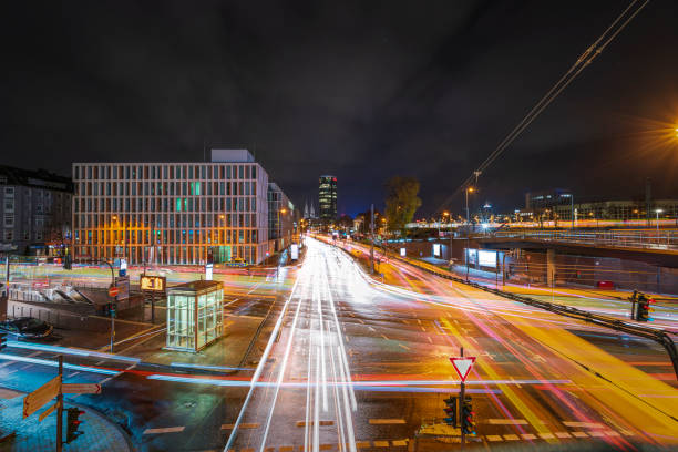 Crossing at night in Cologne with view onto skyline & cathedral