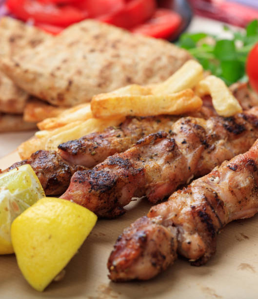 istock Grilled meat skewers on a table, closeup view 1286288575