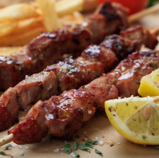 istock Grilled meat skewers on a table, closeup view 1286288582