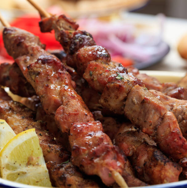 grilled meat skewers on a table, closeup view - opa! souvlaki of greece imagens e fotografias de stock