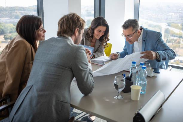 istock Businessman looking closely at plan on sheet at the conference table 1286290028