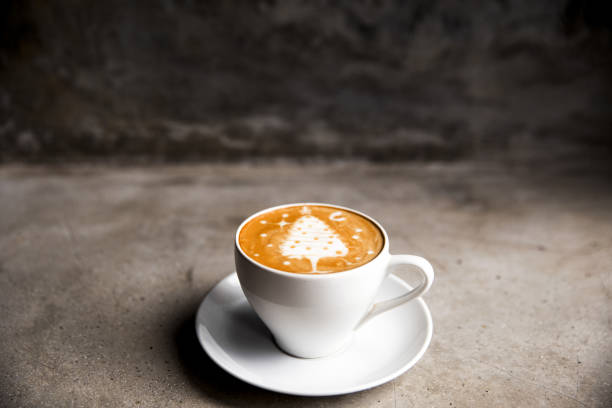 istock Tasty cappuccino with Christmas tree latte art on concrete background. 1286292091