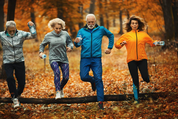 istock Group of mature folks jogging in a forest. 1286292164