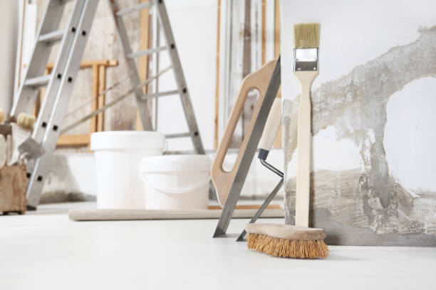 istock Indoor shot close up frontal view of bricklayer, plasterer or house painter tools on white floor with buckets in home renovation site 1286292275