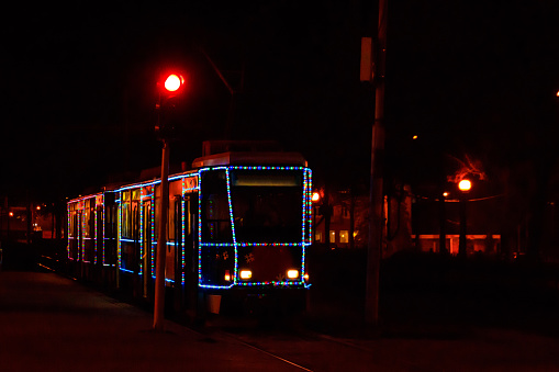 Tram decorated in Christmas lights at night