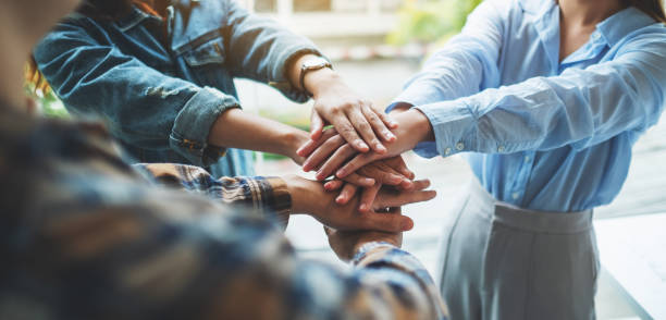 istock business team standing and joining their hands together in office 1286293746