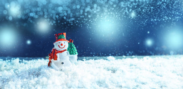 istock Christmas snowman in  wintry background with  snow. 1286294634