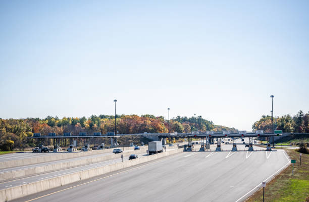 Toll Highway with multi-line payment terminal Wide divided turnpike highway with toll station with multi-line payment terminal for fast payment and working without transportation traffic delay in Maine New England multiengine stock pictures, royalty-free photos & images