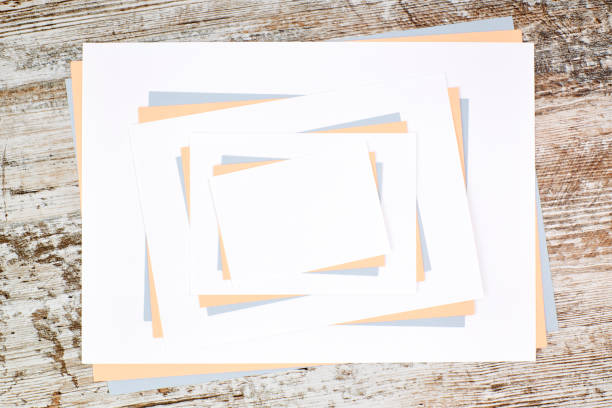 istock Colored paper sheets with copy space on a wooden table 1286297784