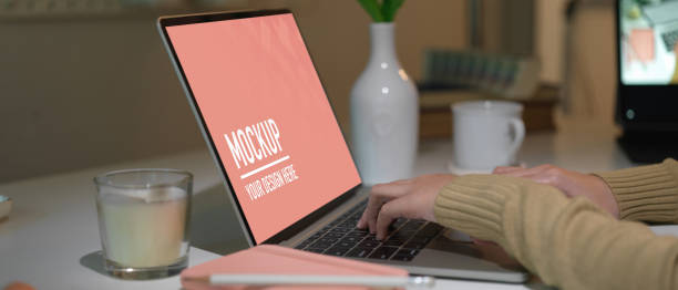 istock Female hands typing on laptop on white table in office room 1286297826