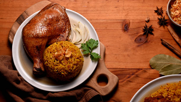 istock Delicious chicken biryani with rice marinated in spices on kitchen table 1286297946