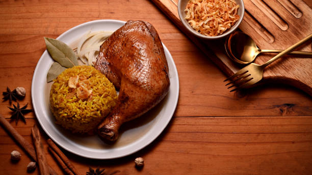 istock Delicious chicken biryani with rice marinated in spices serving with fried onion 1286297978