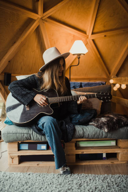 istock Young woman playing guitar 1286299058
