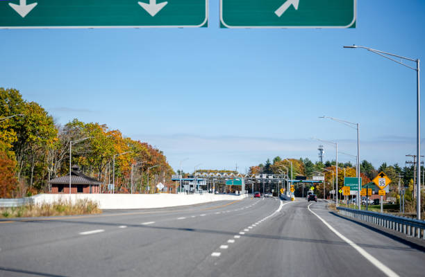 istock Toll split highway with payment terminal and road signs 1286299063
