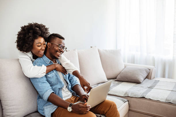 istock Cropped shot of a couple using a laptop while sitting on the sofa. 1286299064
