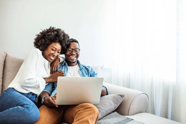 istock Cropped shot of a couple using a laptop while sitting on the sofa. 1286299127