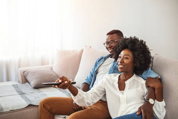 istock Couple at home watching TV. 1286299322
