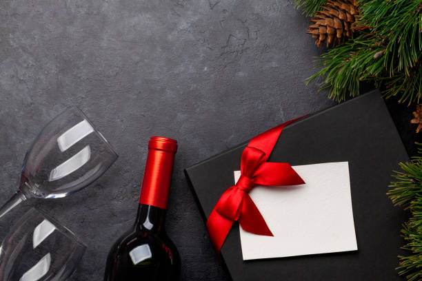 istock Christmas greeting card with fir tree, wine and gift box 1286300422