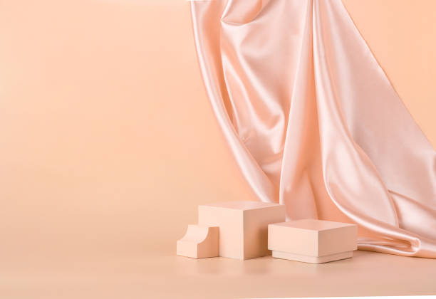 istock Modern abstract podium on pastel monochrome background with shiny draped fabric 1286300559
