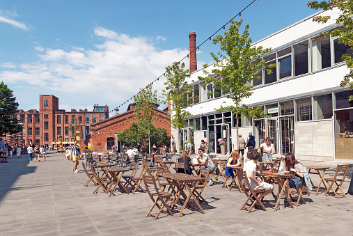 Saint-Petersburg, Russia – July 18, 2020: People rest in the open air cafe in the modern public and creative space Sevkabel Port on The Vasilyevsky Island