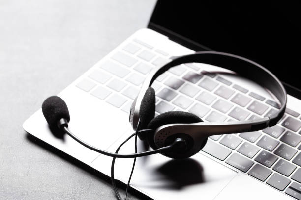 istock Office desk with headset and laptop 1286301661