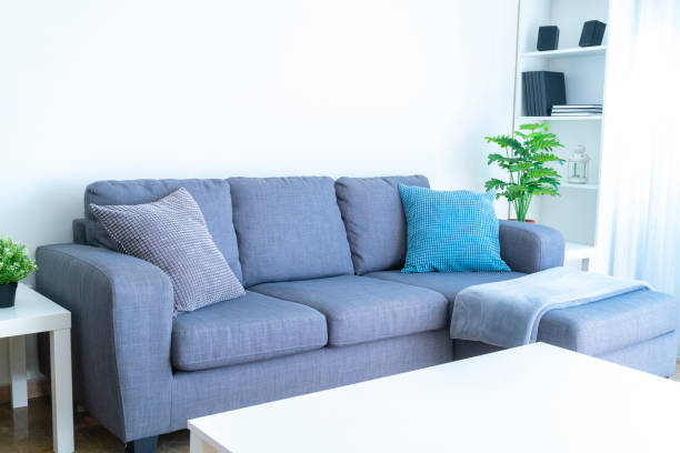 istock Modern gray couch with blanket and pillow 1286303839
