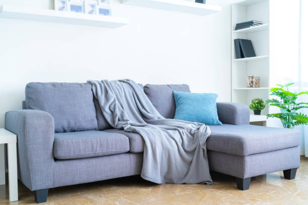istock Living room interior: gray couch with blanket and pillow 1286303859
