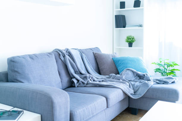 istock Living room interior: gray couch with blanket and pillows 1286303862