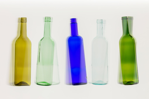 five colorful empty wine bottles