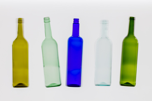 five colorful empty wine bottles