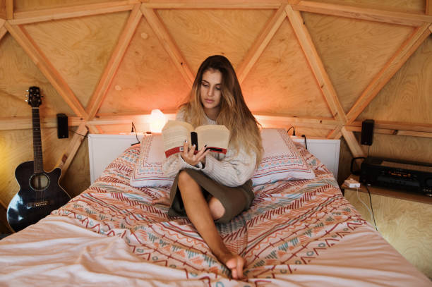 istock Young woman reading and lying on bed 1286307464