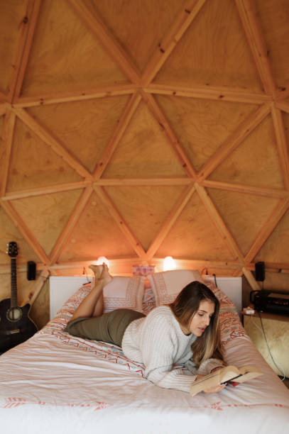 istock Young woman reading and lying on bed 1286307833