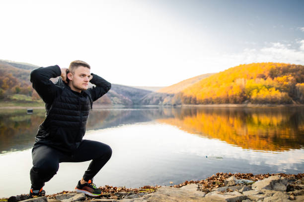 istock Athlete man crouching on the lake's waterfront 1286307845