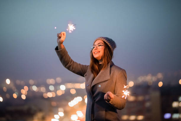 istock Girl holding burning sparklers on the rooftop 1286308514