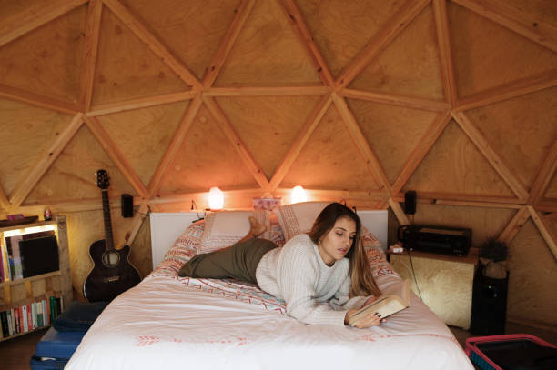 istock Young woman reading and lying on bed 1286308794