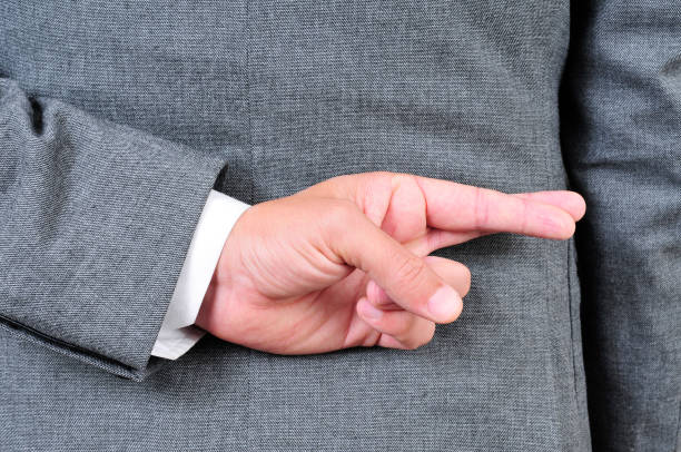 istock man in suit crossing his fingers in his back 1286308959