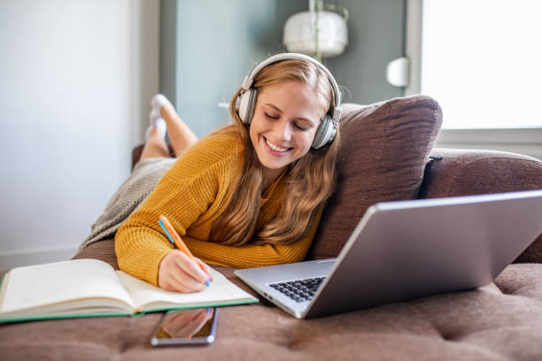 istock Young woman studying with laptop at home 1286309818