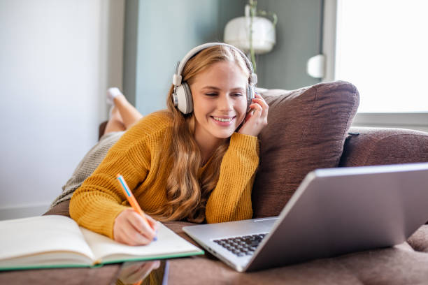 istock Young woman studying with laptop at home 1286309819