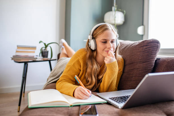 istock Young woman studying with laptop at home 1286310112